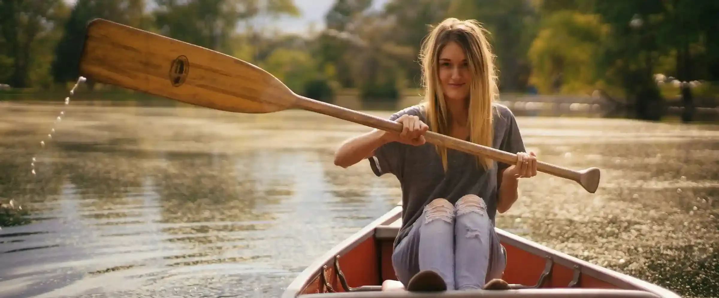 A young woman rowing a boat